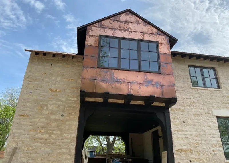 Copper metal panel facade on a stone building for Roof Repair in Grovetown